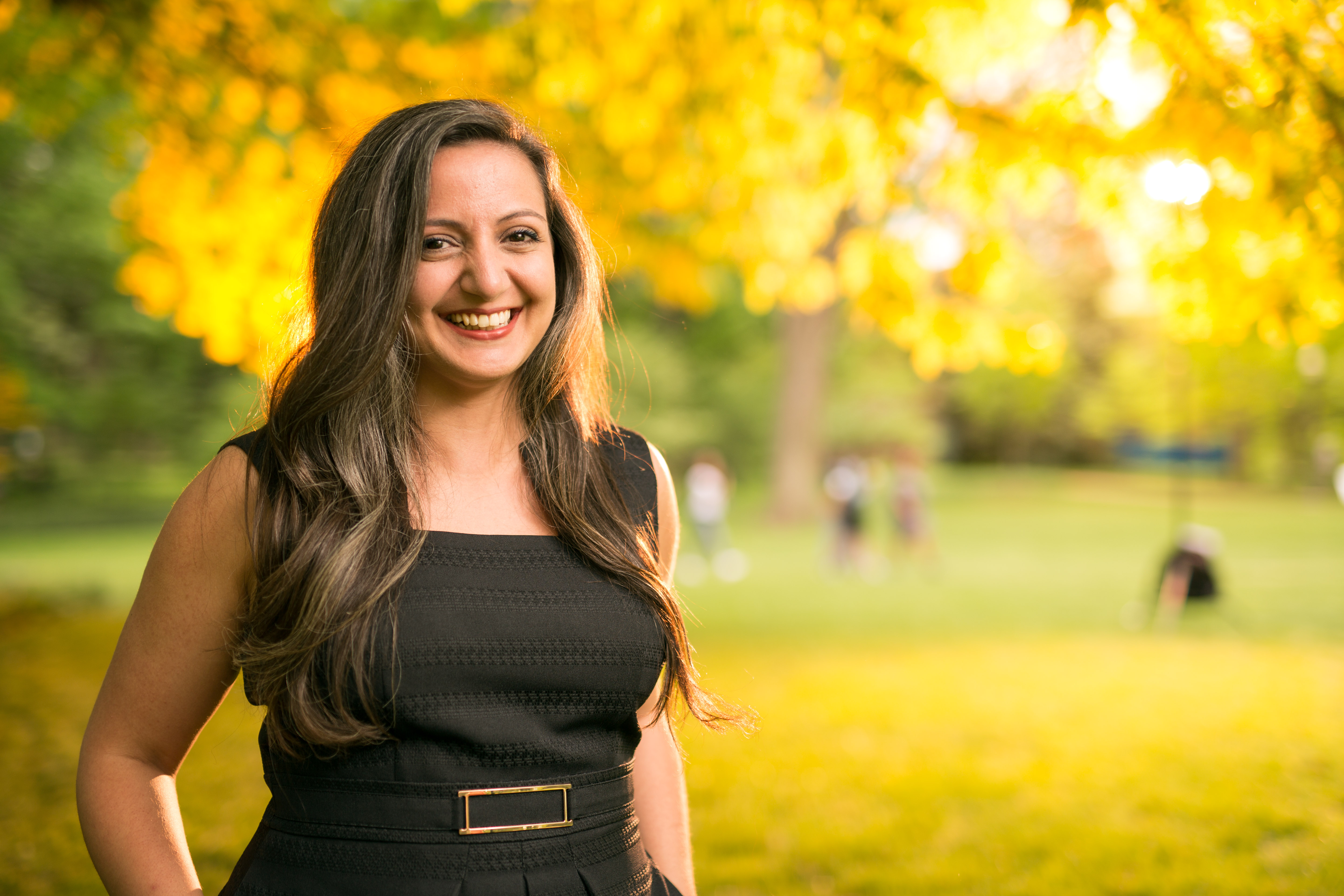 Image of Vanderbilt School of Engineering's Hiba Baroud standing outside with yellow and green trees in the background