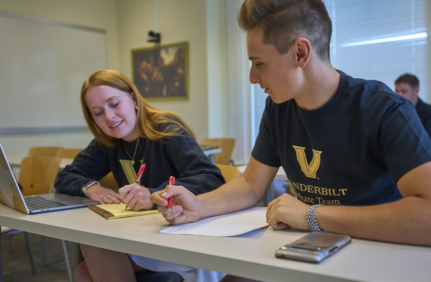 Vanderbilt Debate team members take notes during a debate event