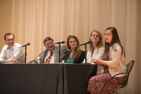 teacher legislature peabody meeting participants seated on stage behind a table