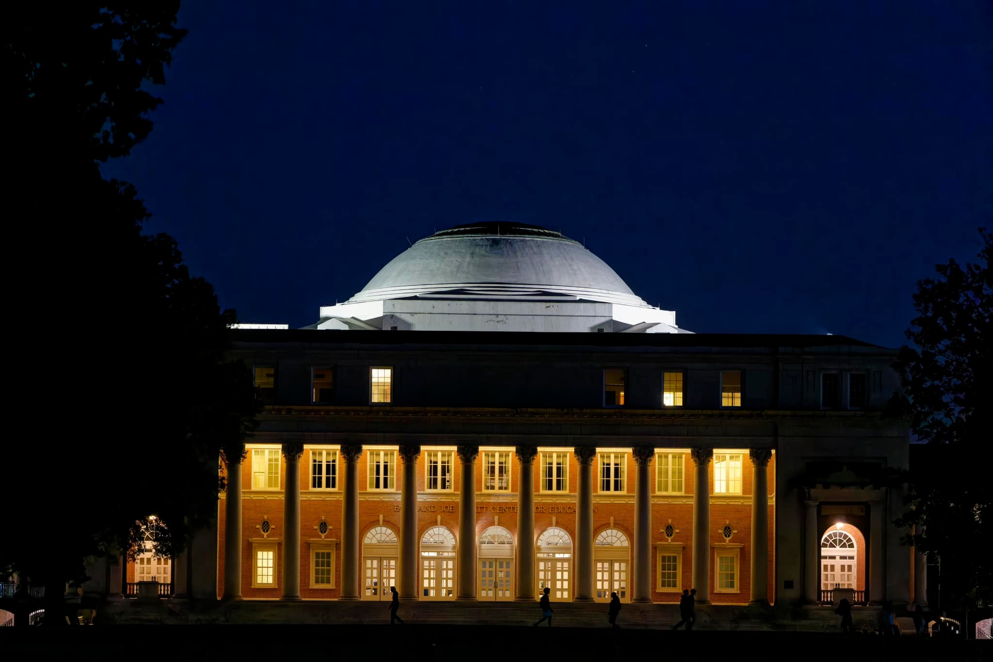 Peabody College glows with light on a dark campus night