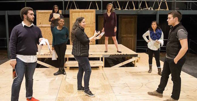 students rehearsing on stage