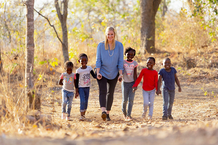 Katie McGinnis with the children she serves through Family Legacy