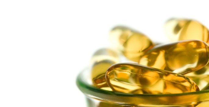 close-up of fish oil capsules in a glass bowl