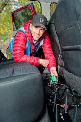 Dan Work shows the mechanism connecting the AI-powered cruise control system for the research project. (Vanderbilt University)