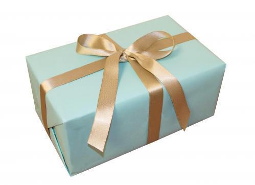 a box neatly wrapped in light blue paper with a gold bow