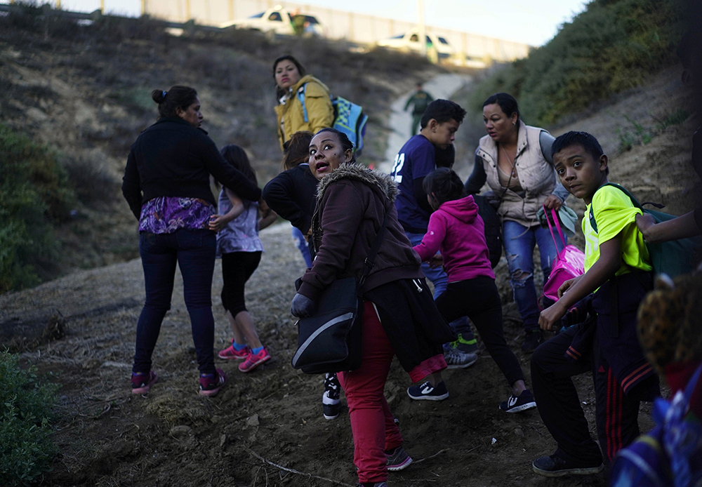 photo of immigrants crossing the US-Mexico border