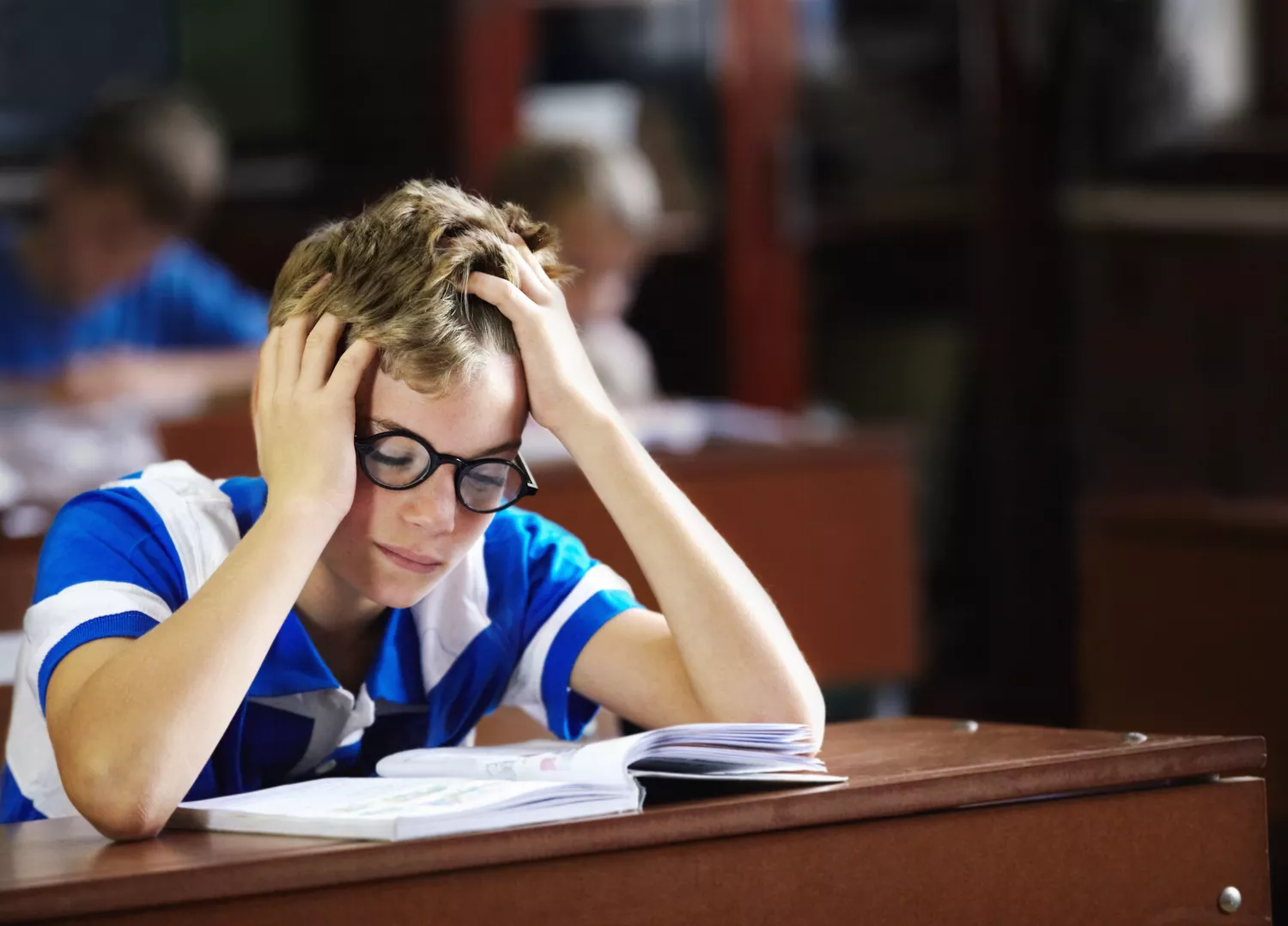 student struggling to read at desk