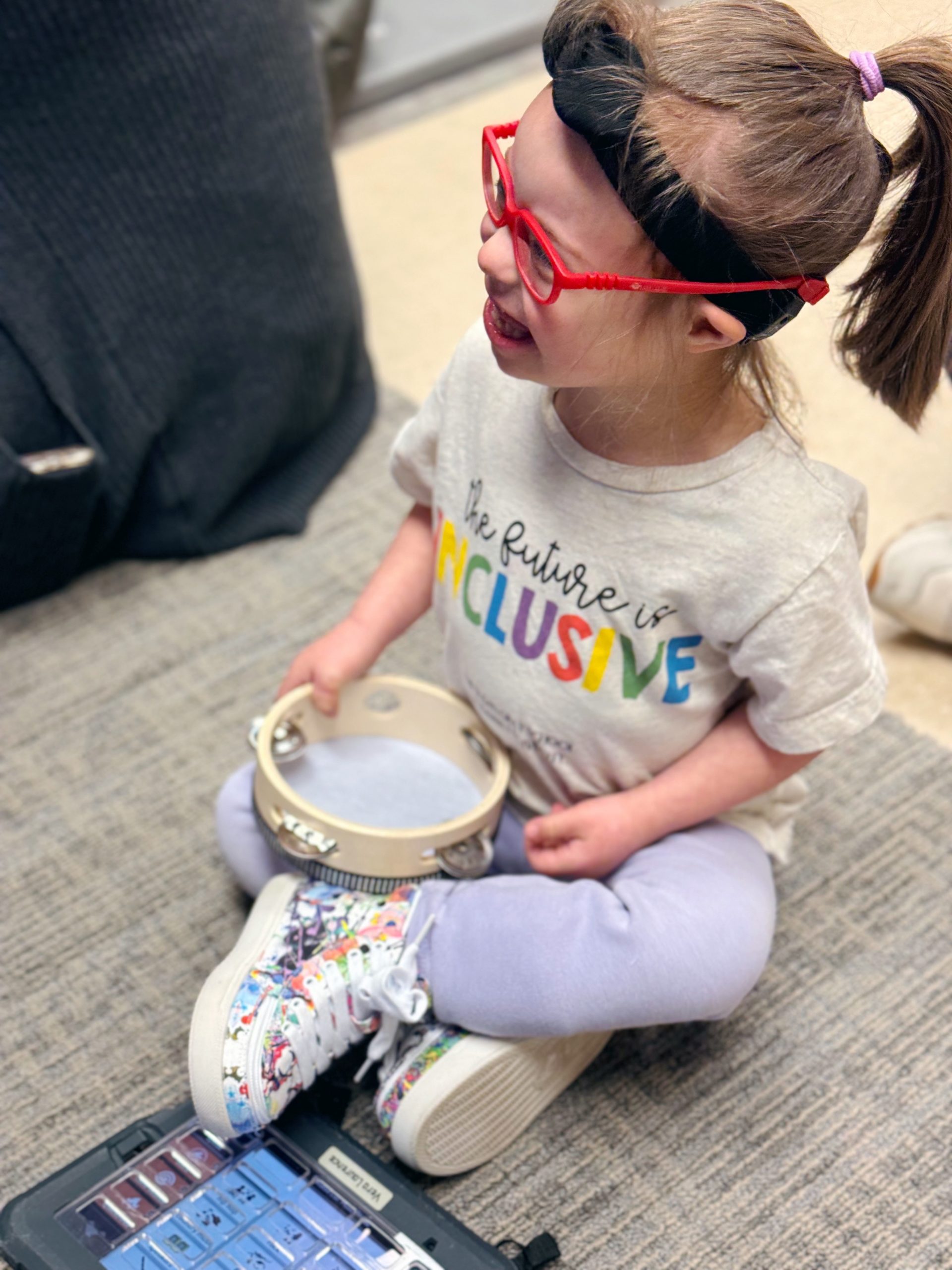 The Susan Gray School - child with tambourine and talker
