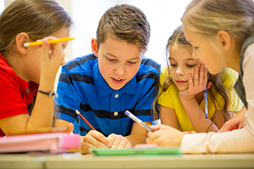 four students working at a table