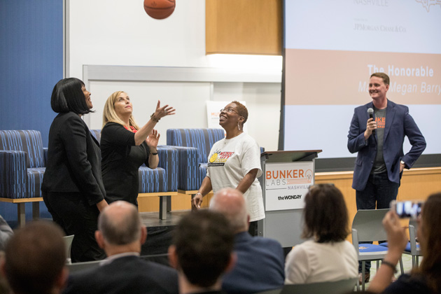 Mayor Megan Barry facilitates a jump ball with Music City Icons founder Renee Bobb (left) at the Muster Across America launch May 24 at the Wond'ry. (John Russell/Vanderbilt)