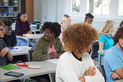 one student looking around class