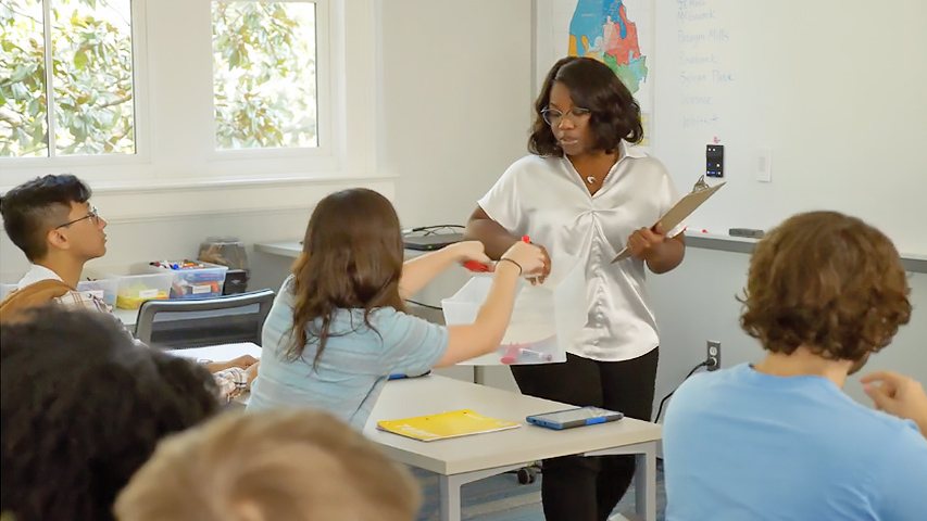teacher conferring with one student