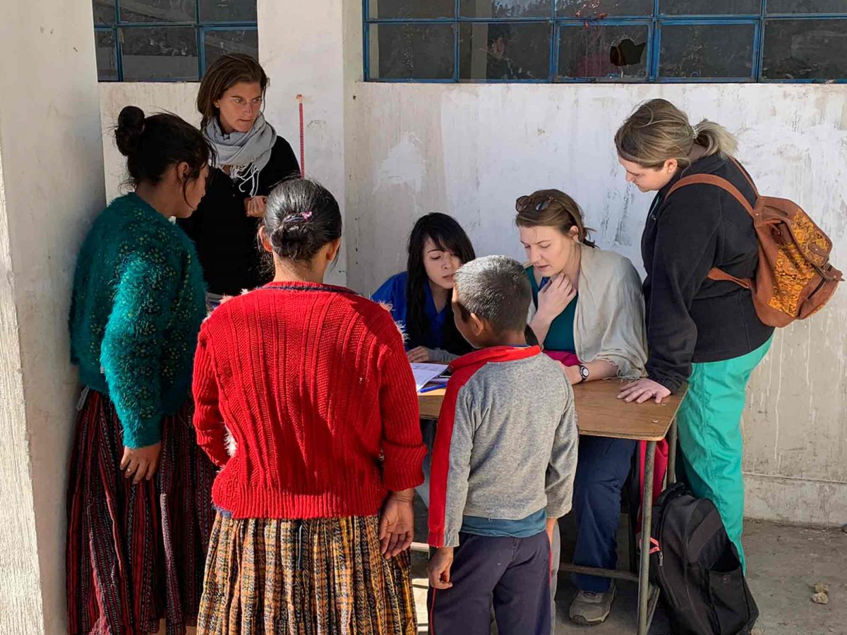 Nursing students and patients learn at an outdoor table
