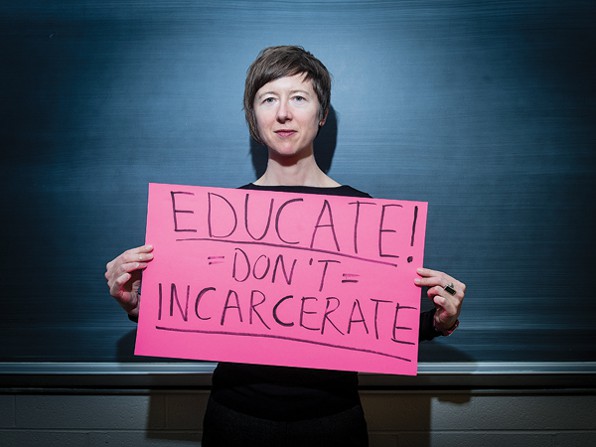 Lisa Guenther holding sign that says 