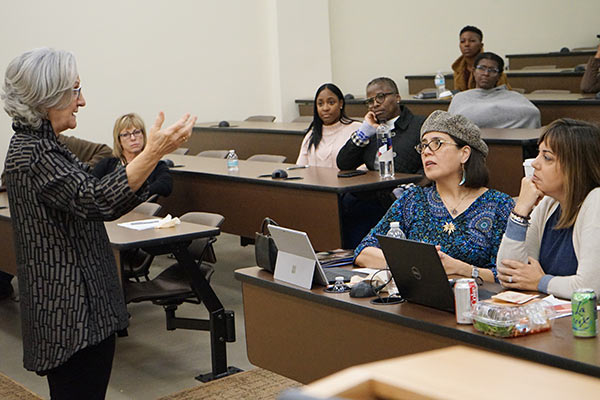 DNP students sit in a classroom listening to visiting professor Tonda Hughes