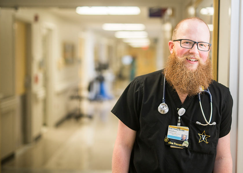 VUSN student Brett Young on the job at VUMC, standing just inside a doorframe