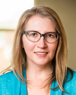 Headshot of Julia Phillippi in her office. She's wearing a turquoise sweater.