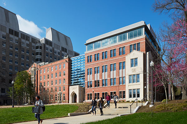 Front view of new Vanderbilt School of Nursing building on a sunny day with students walking down steps to the street