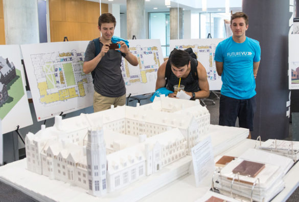 Students look at a 3D model of the residential college being constructed at the former Vanderbilt Barnard site. (Joe Howell/Vanderbilt)