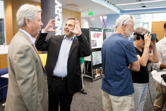 Vice Chancellor for Administration Eric Kopstain (second from left) at the FutureVU Expo's virtual reality viewing station. (Joe Howell/Vanderbilt)