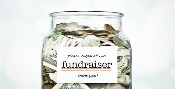 Glass jar filled with donated money for a fundraiser