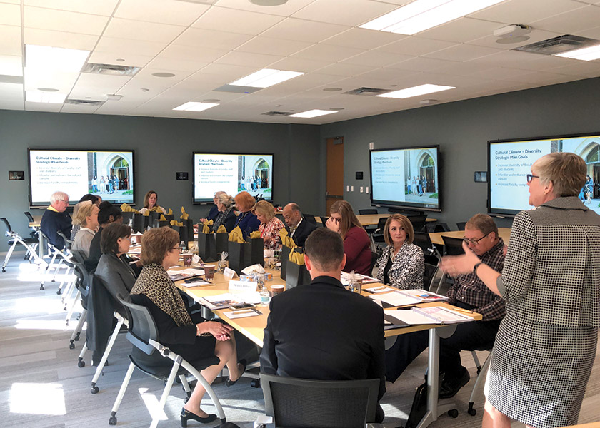 VUSN friend and alumni in a meeting room while Sr. Associate Dean Mavis Schorn presents