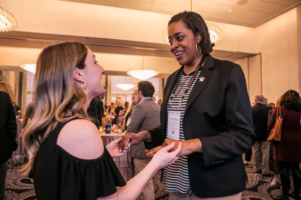 Vice Chancellor Candice Lee speaks to an attendee during Volunteer Leadership Weekend.