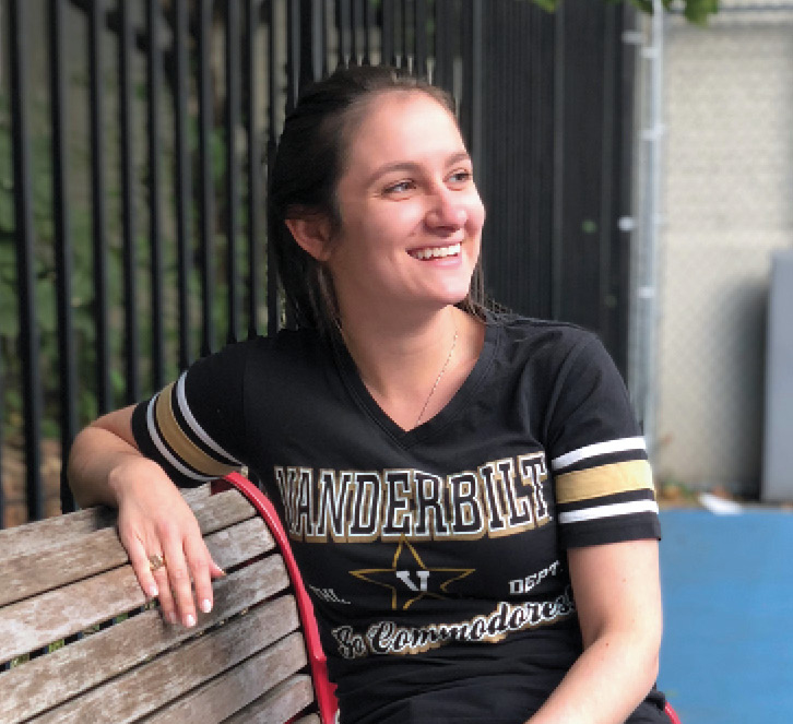 Color portrait of Sarah D'Amico in black and gold Vanderbilt Commodores shirt