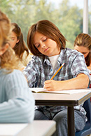 Boy writing at his desk