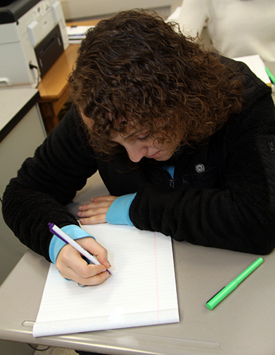 Erin taking notes on a notepad