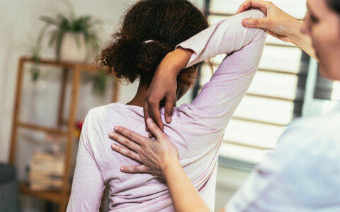 Provider checking a child's spine