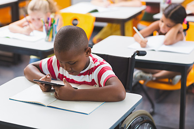 boy in wheelchair at desk