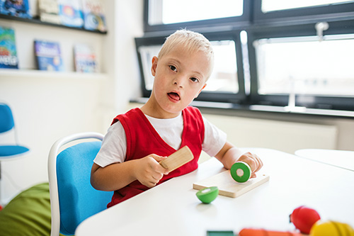 young boy with objects at table