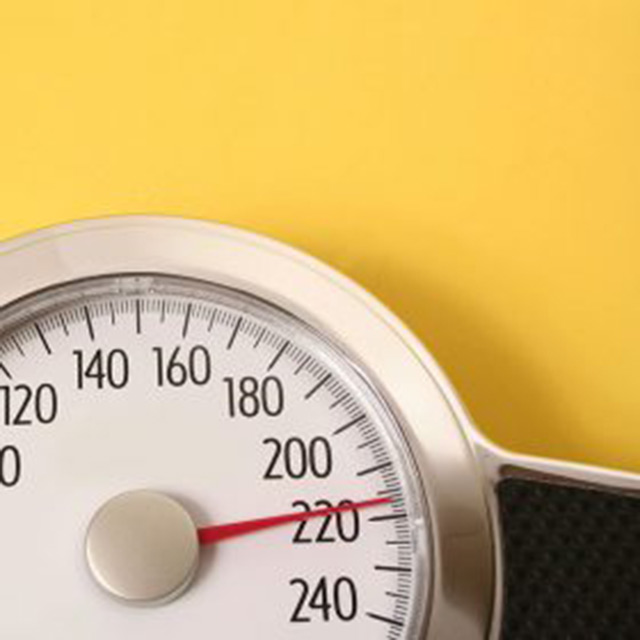 Portion of an analog scale against a yellow background