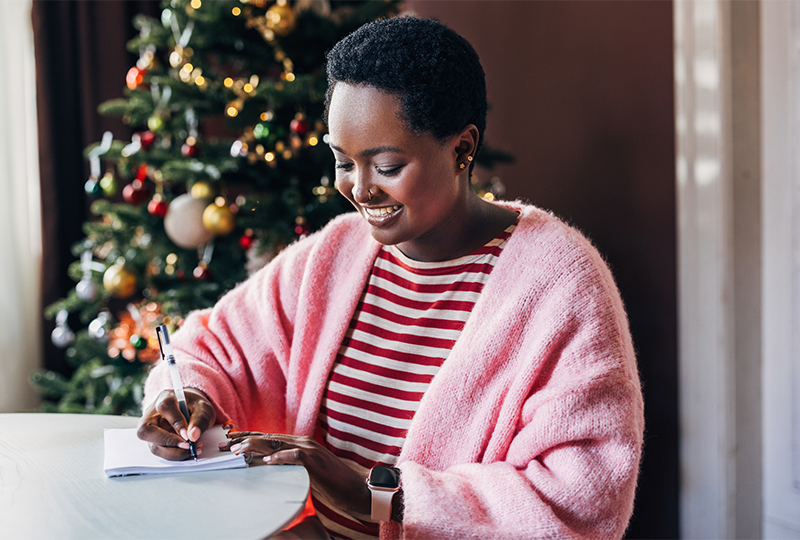 Woman writing new years resolutions