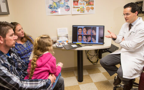 Dr. Stephan consulting with pediatric patient and family
