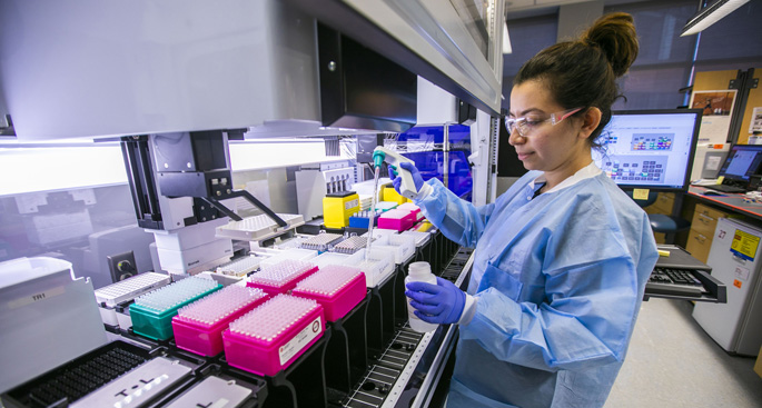 Research assistant Mahsa Majedi loads reagent used in DNA sample preparation in the genomics lab. She is part of a team of more than a dozen people at VUMC who are “sprinting” to develop — within 90 days — an antibody-based treatment to stop the spread of the Zika virus.