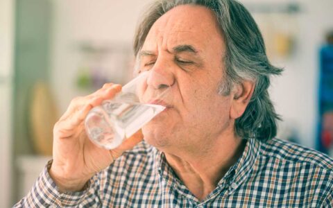 Older man drinking water