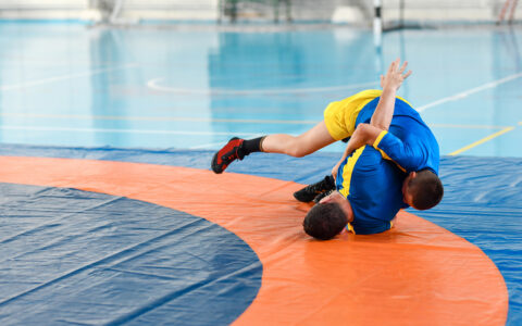 Sparring session with two teenage wrestlers in a gym