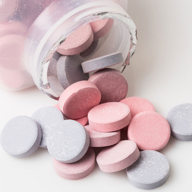 Using Tums for quick heartburn relief.