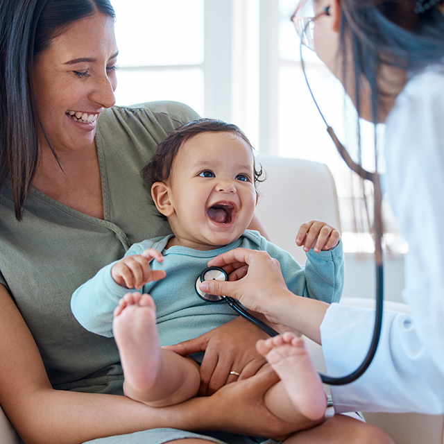 Baby with doc listening to lungs