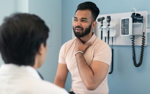 Young man at a checkup to investigate throat issues