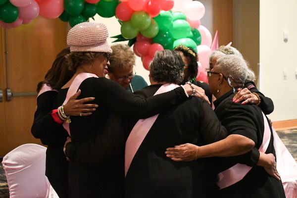 Original members of the Eta Beta chapter of AKA at their 50th anniversary reunion in a group hug
