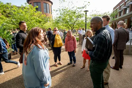 Faculty members socialize at the Spring Faculty Assembly reception.