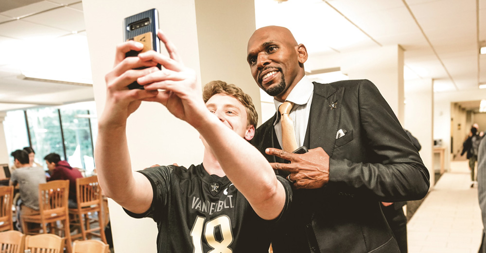 photo of Jerry Stackhouse taking a selfie with a student