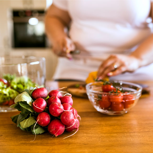 Diabetic patient cooking healthy meal to combat NAFLD.