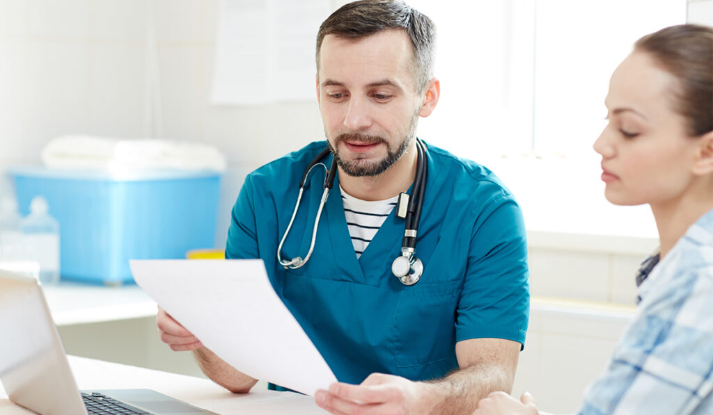 Doctor reading test results to patient