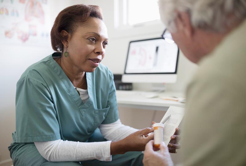Doctor going over a valsartan prescription with a patient.