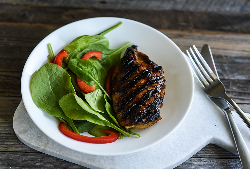 Chicken breast, done cooking, on a grill