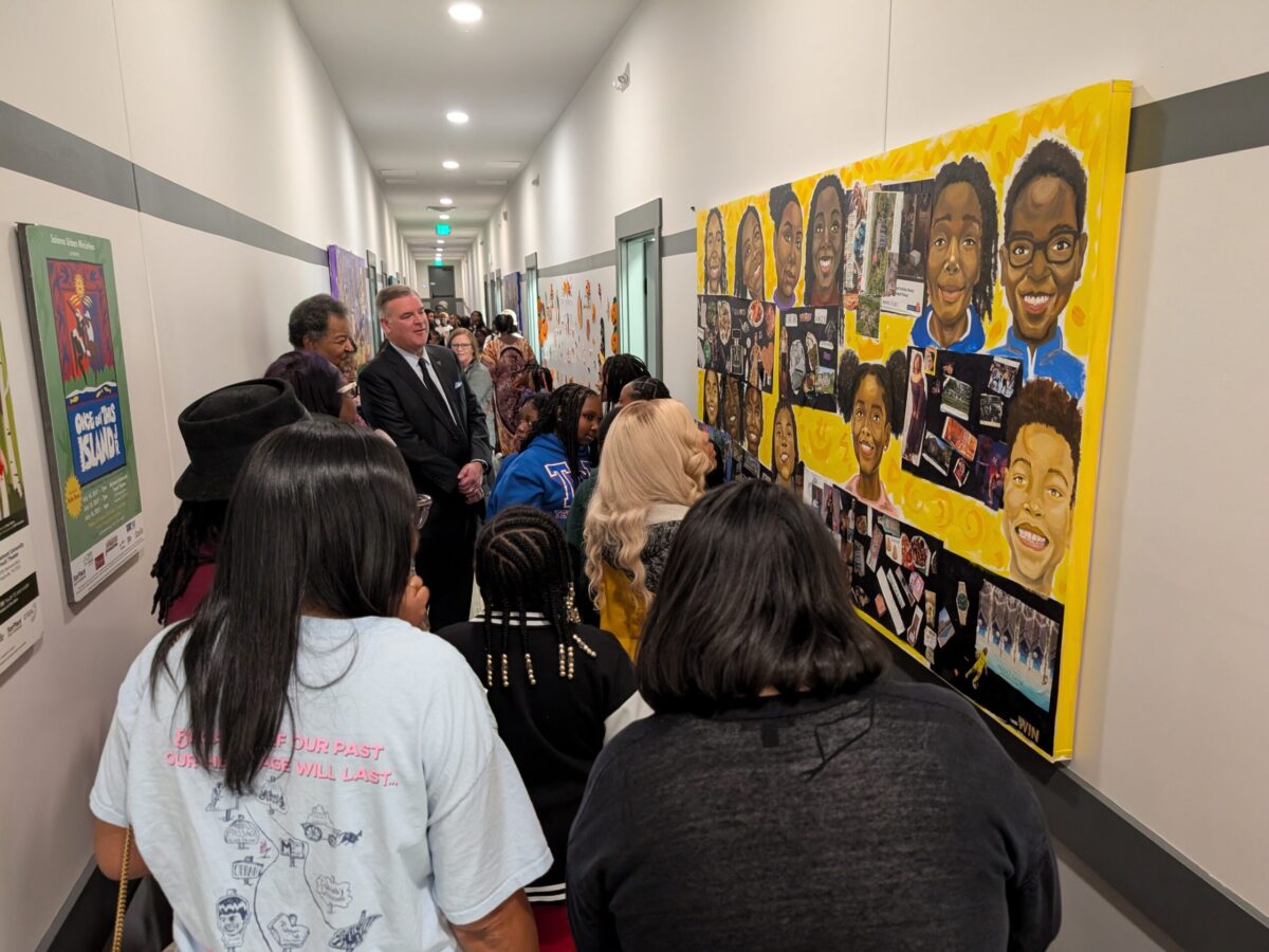 Group photo in front of the Salama Ministries mural